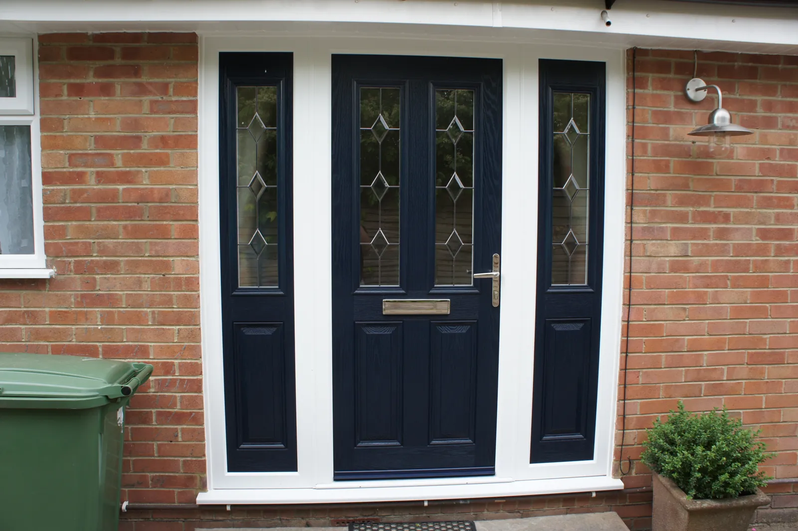 A navy composite front door with matching side panels