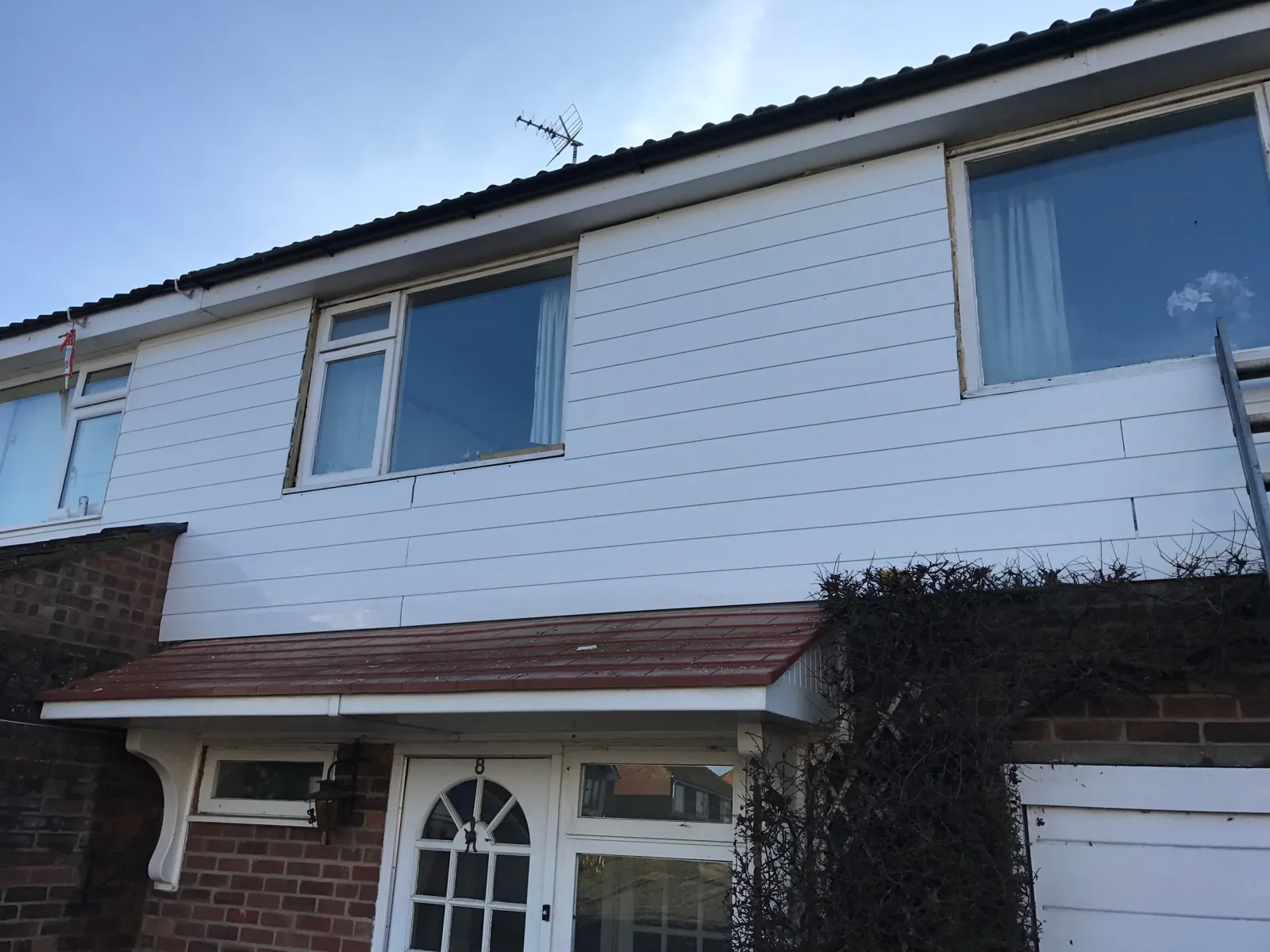 New white fascias, guttering and shiplap cladding on a house